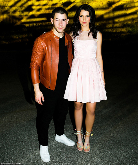 The best present ever: The birthday girl made sure to pose for a picture with 23-year-old Nick, showing off the second of two pink dresses she wore on the night