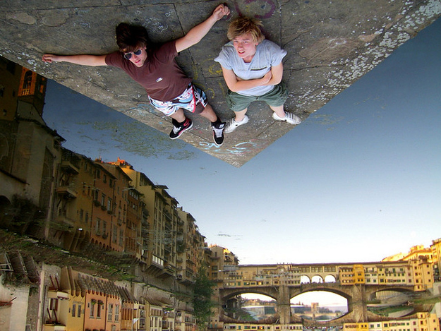 7. Thật là bức ảnh 'hại não' nhất quả đất nhưng nếu bạn quay ngược tấm ảnh sẽ thấy hai anh chàng này đang nằm trên một tấm ván nổi trên mặt sông, nước trong vắt đã tạo ra hình ảnh phản chiếu của cây cầu và các tòa nhà xung quanh.