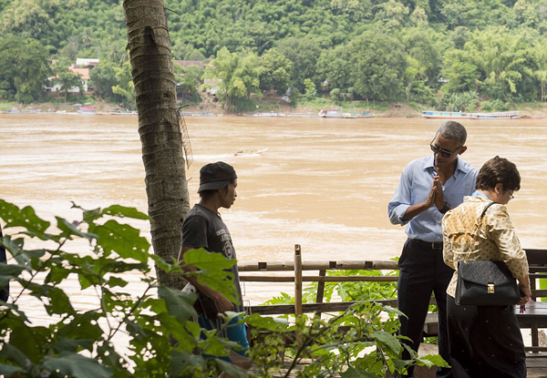 Pleased to meet you: US President Barack Obama gestures a traditional greeting to a local as he tours alongside the Mekong River in Luang Prabang