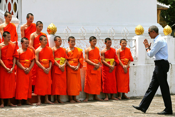 His first stop in the city was Wat Xieng Thong, a 16th century complex of ornate gold buildings known as the Temple of the Golden City.  Greeting the temple monks, Obama tried to shake hands with about 20 boys in bright orange robes, but was informed by his guide they werent supposed to shake hands.  Instead, he posed for a group photo before heading to a shop to buy gifts for daughters Sasha and Malia.